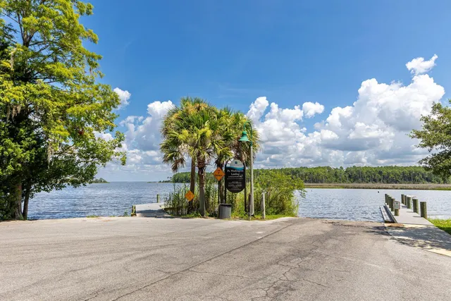 a view of house with deck and outdoor seating