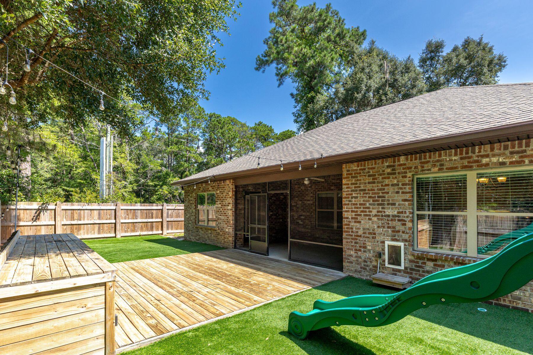 20 Big Oak Lane Santa Rosa Beach, FL 32459 - Photo 3 of 31 a view of a backyard with a barbeque grill and wooden fence