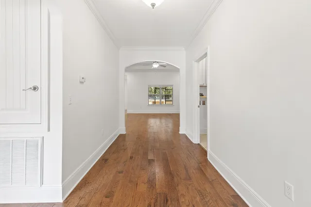 a view of a hallway with wooden floor
