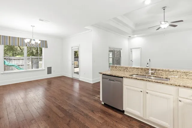 an empty room with wooden floor and window