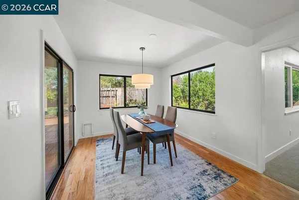 a view of a dining room with furniture window and wooden floor
