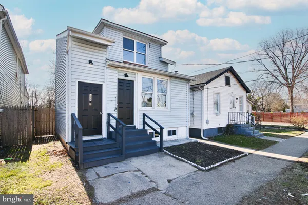 a view of house with backyard and seating space