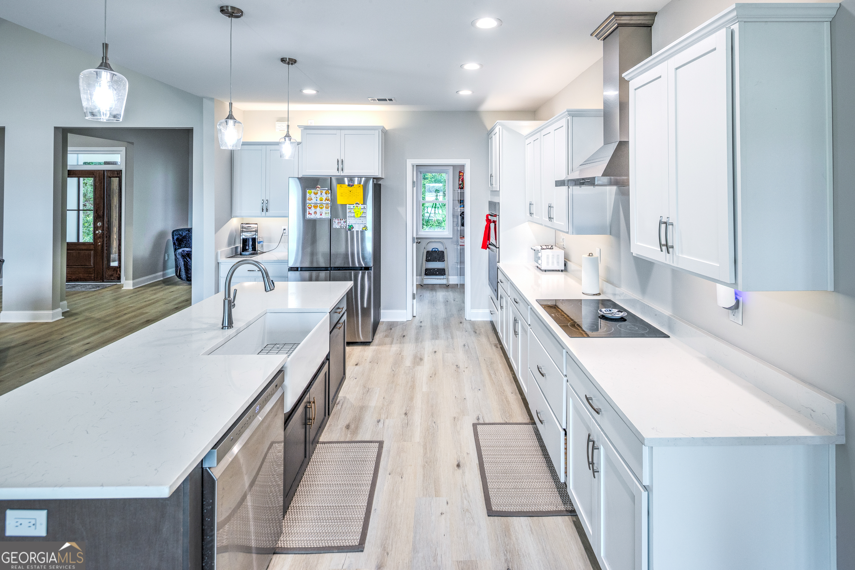 87 Lighthouse Way Woodbine, GA 31569 - Photo 17 of 116 a large kitchen with kitchen island a large counter top space a sink stainless steel appliances and cabinets