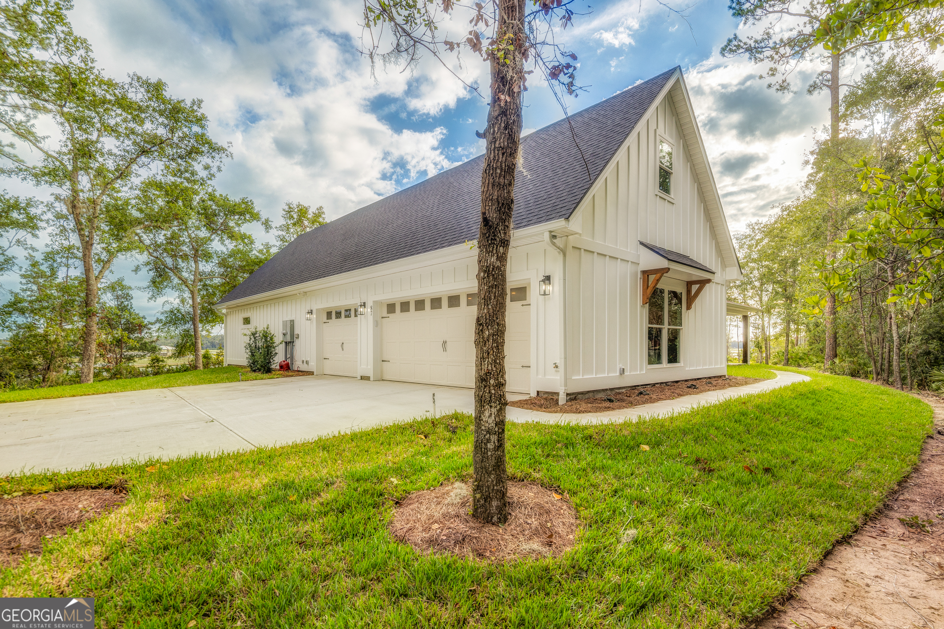 87 Lighthouse Way Woodbine, GA 31569 - Photo 29 of 116 a front view of a house with a yard and garage