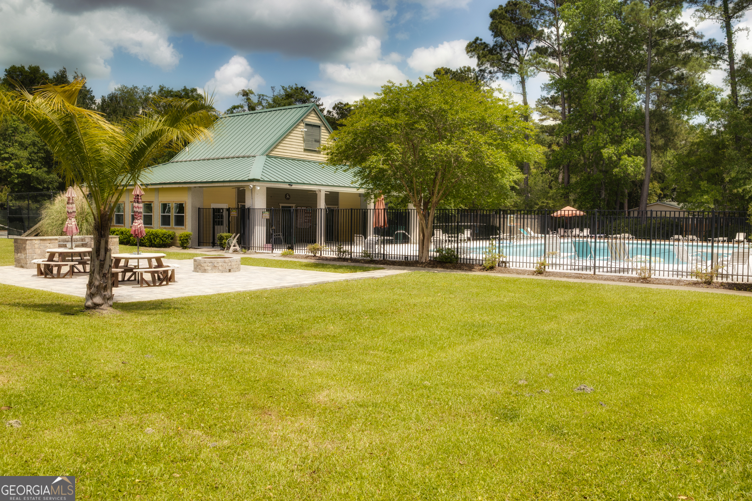 87 Lighthouse Way Woodbine, GA 31569 - Photo 36 of 116 a swimming pool with outdoor seating and yard