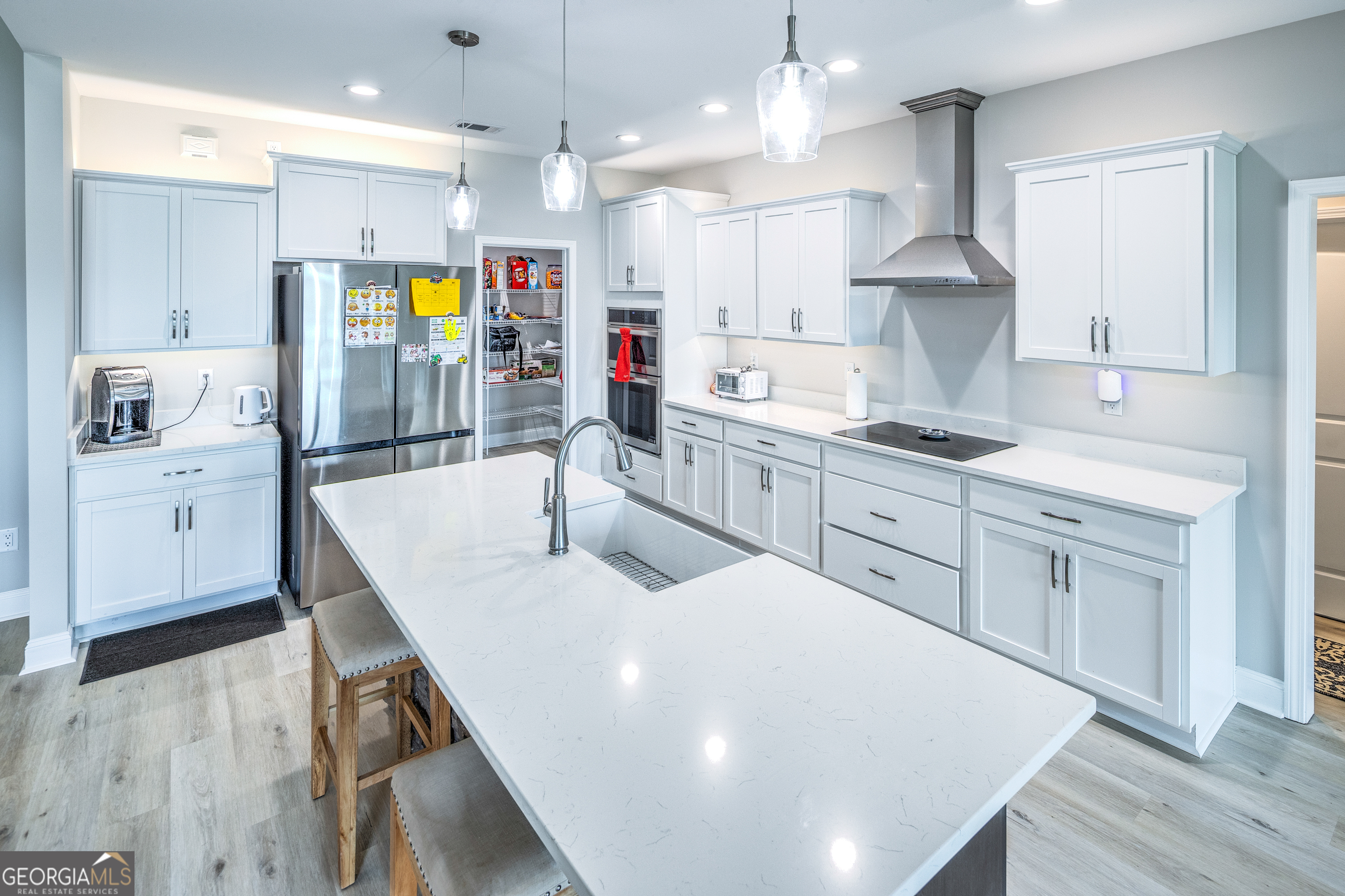 87 Lighthouse Way Woodbine, GA 31569 - Photo 4 of 116 a kitchen with stainless steel appliances kitchen island granite countertop a sink a stove a dining table and chairs