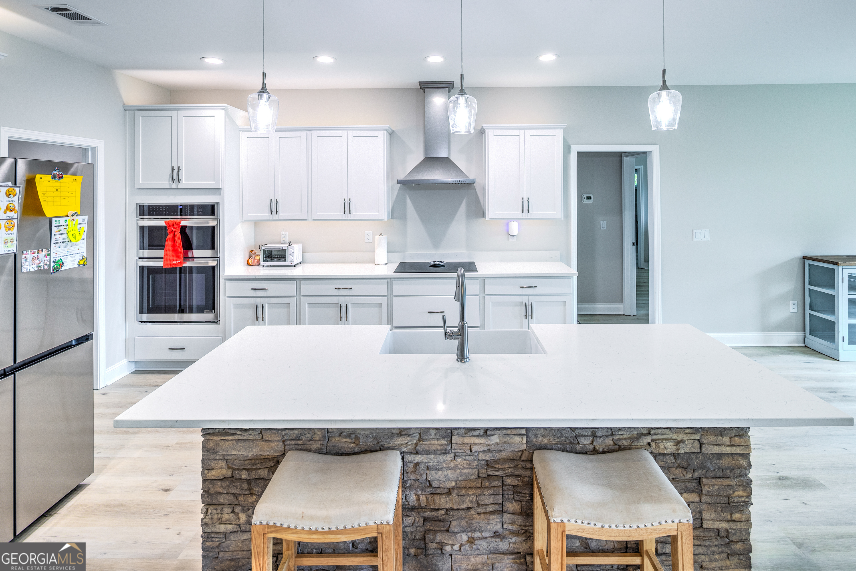 87 Lighthouse Way Woodbine, GA 31569 - Photo 43 of 116 a kitchen with kitchen island granite countertop a sink a center island stainless steel appliances and cabinets