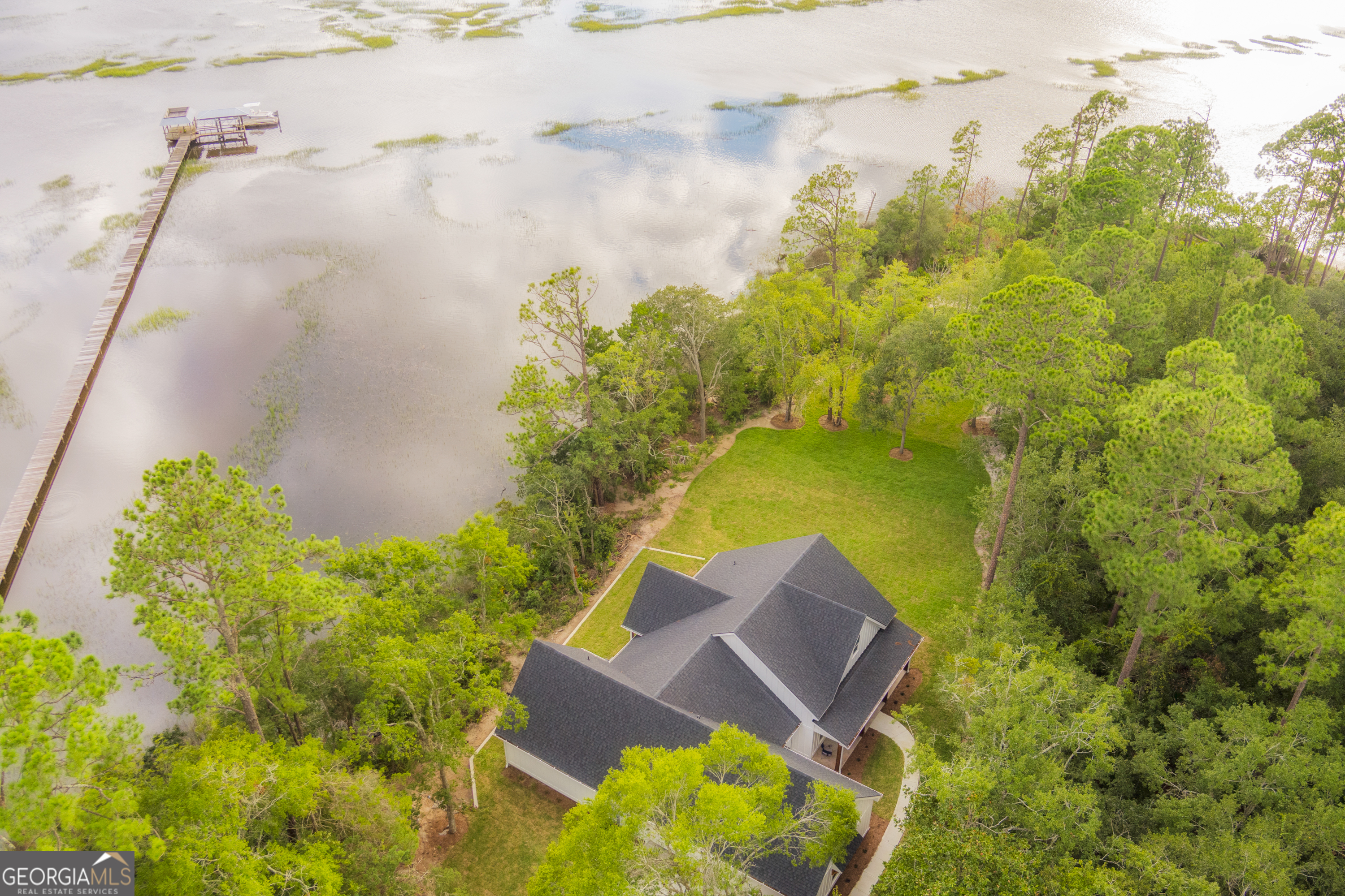 87 Lighthouse Way Woodbine, GA 31569 - Photo 50 of 116 a view of a lake with a building in the background