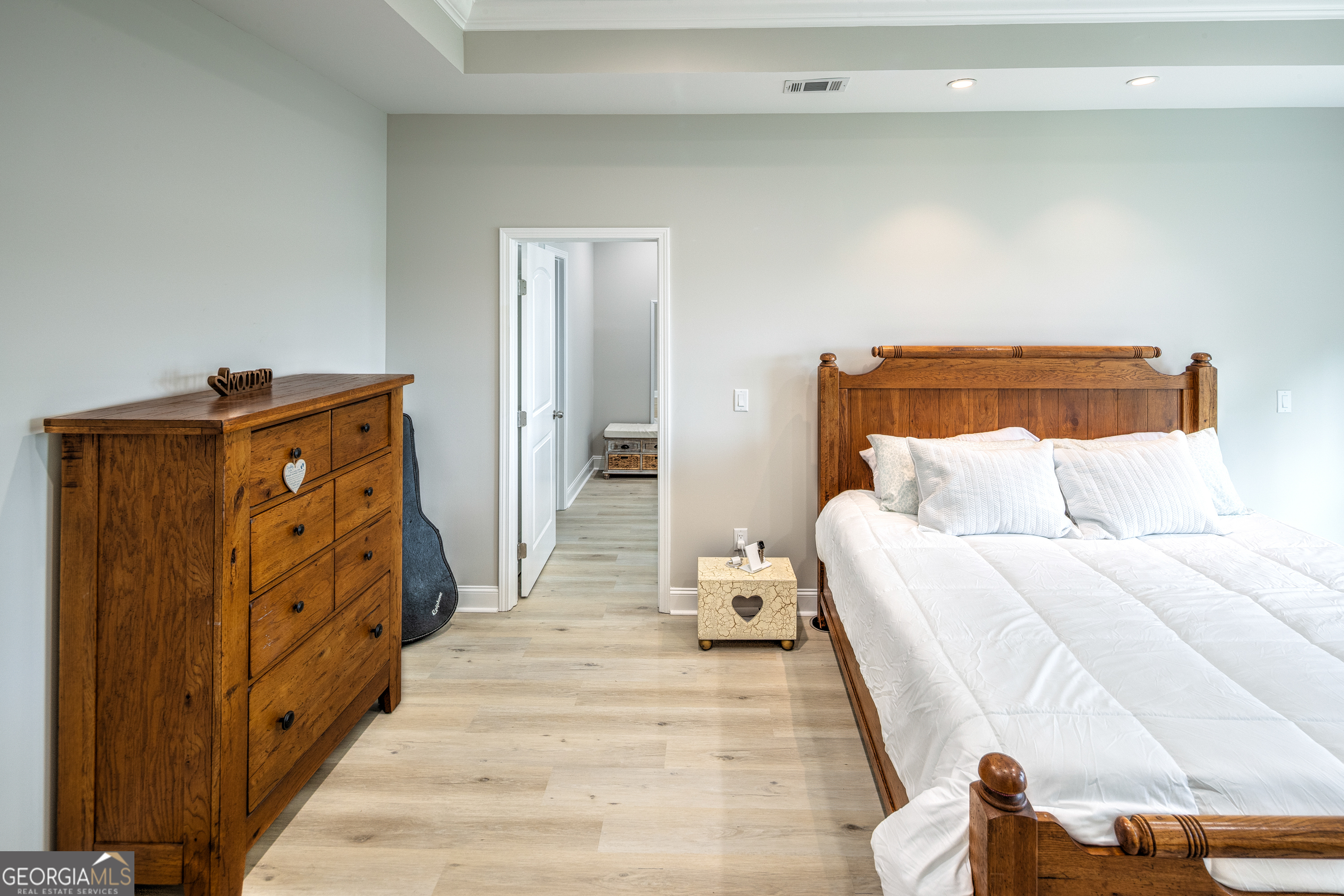 87 Lighthouse Way Woodbine, GA 31569 - Photo 74 of 116 a spacious bedroom with a bed and wooden floor