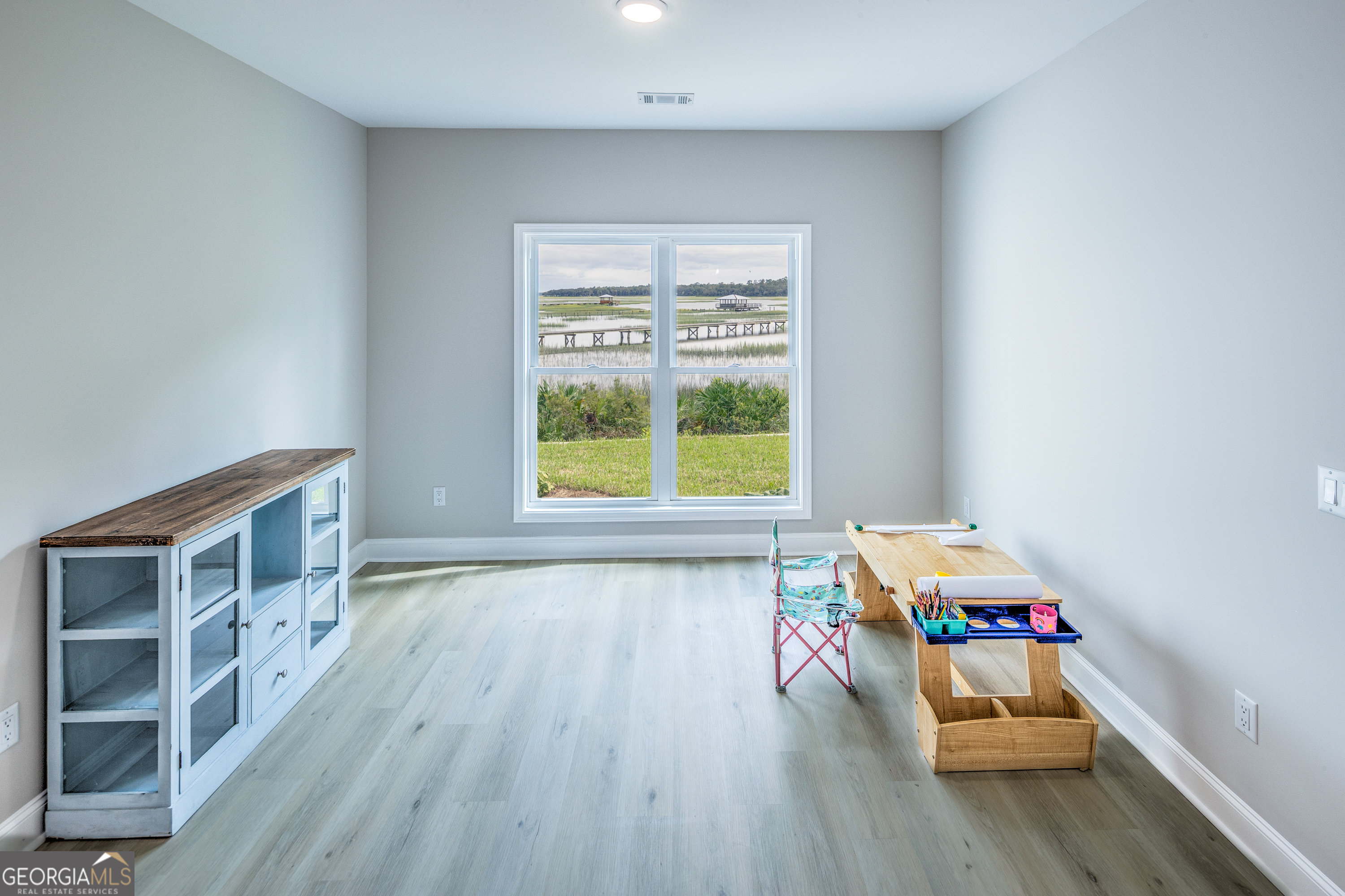 87 Lighthouse Way Woodbine, GA 31569 - Photo 8 of 116 a room with wooden floor and a window
