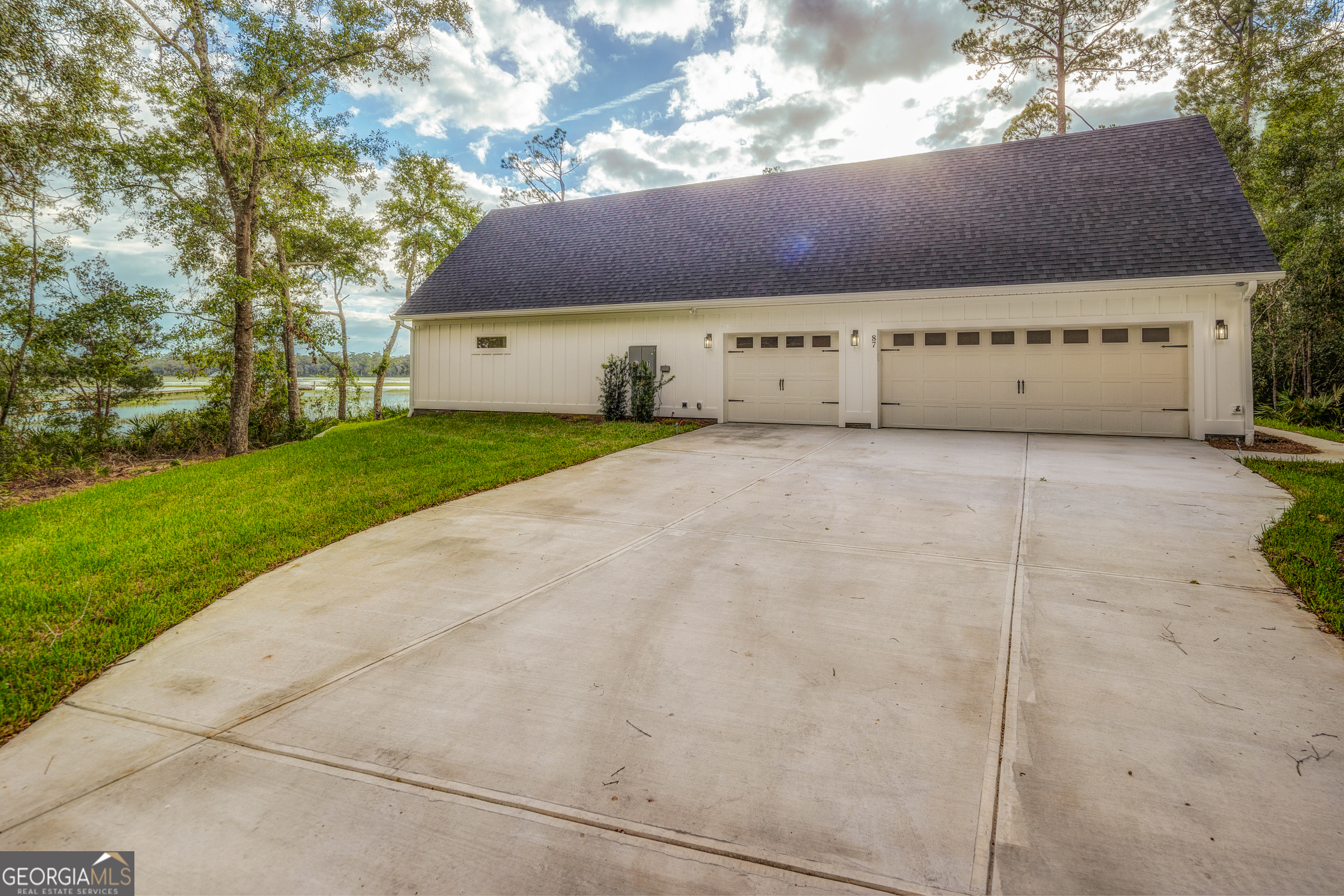 87 Lighthouse Way Woodbine, GA 31569 - Photo 81 of 116 a front view of a house with a yard and garage