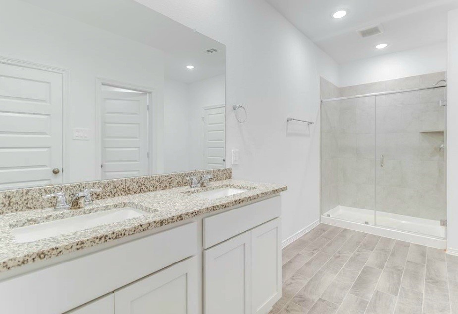 14423 Sunny Bend Way Conroe, TX 77303 - Photo 7 of 9 a bathroom with a granite countertop sink and a mirror