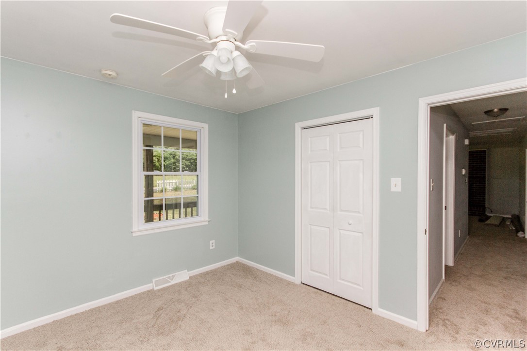 14912 Nash Road Chesterfield, VA 23838 - Photo 29 of 31 an empty room with chandelier fan and windows