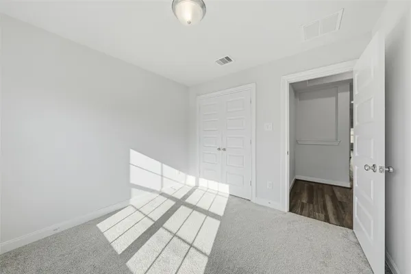 a view of a bedroom with wooden floor
