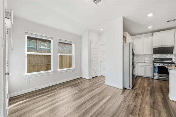 a view of a kitchen with a stove cabinets and wooden floor