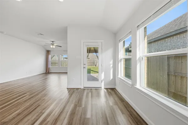 a view of a room with wooden floor staircase and a hallway
