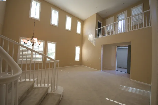 a kitchen with granite countertop a sink a stove and cabinets