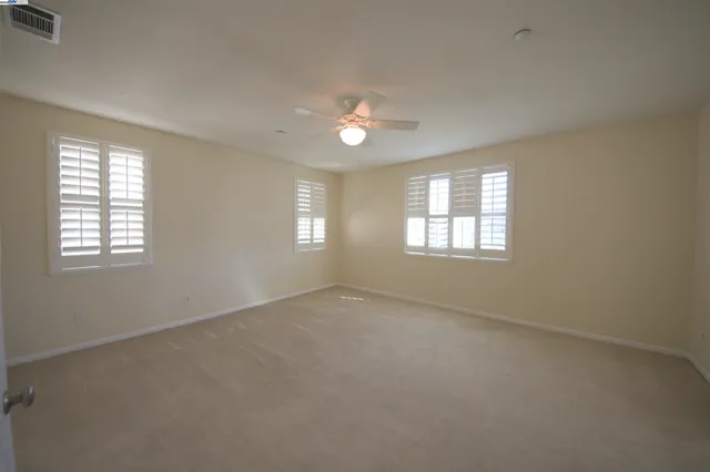 an empty room with windows and entrance