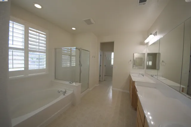 a bathroom with a granite countertop sink