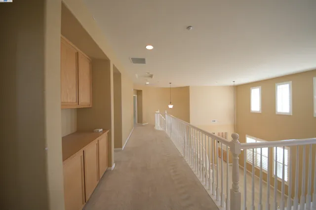 a view of an empty room with windows