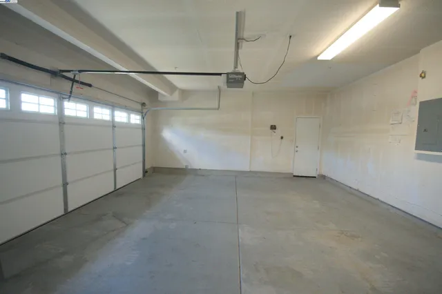 a view of a house with backyard and trees