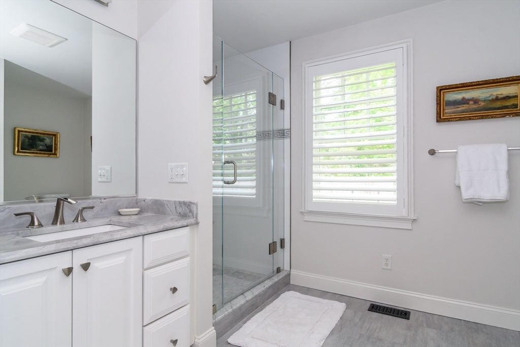 1098 Webster Street Needham, MA 02492 - Photo 12 of 21 a bathroom with a granite countertop sink a mirror and a shower