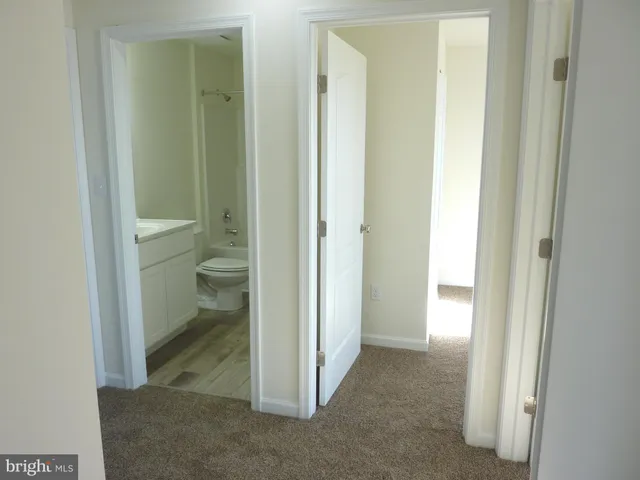 a view of a bathroom from a hallway with toilet