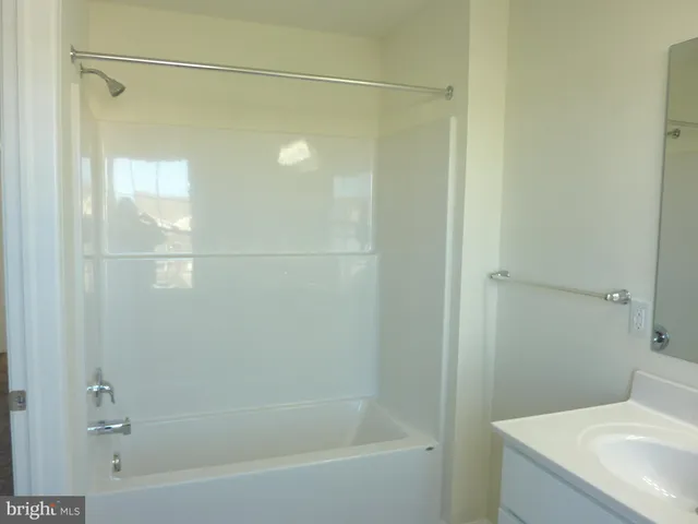 a bathroom with a shower and a sink