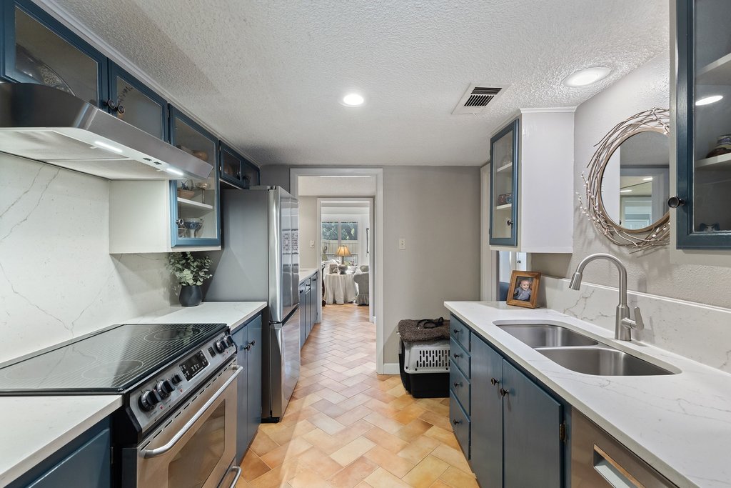 3500 Enfield Road, Unit E Austin, TX 78703 - Photo 19 of 40 Quartz counters blanket the spacious galley-style kitchen.