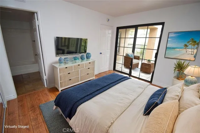 an empty room with wooden floor and a bathroom
