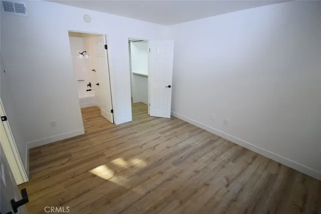 a bathroom with a toilet a sink a mirror and vanity