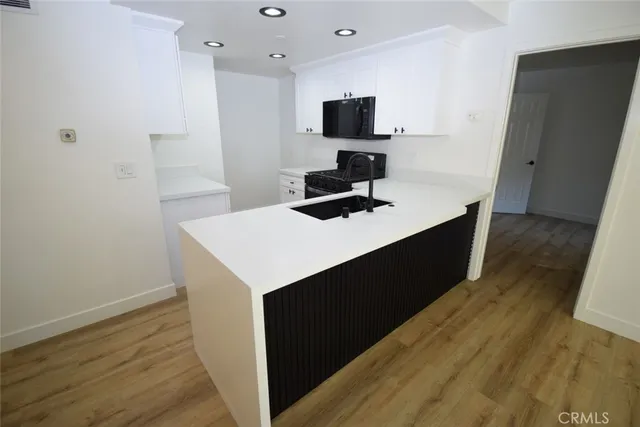a kitchen with a sink and a refrigerator