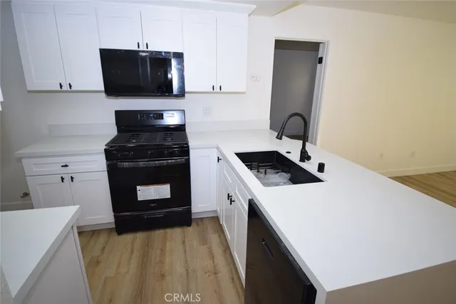 a kitchen with a sink stove and cabinets