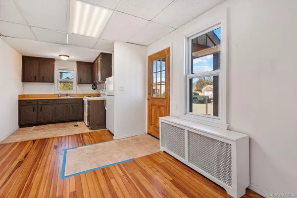a view of a kitchen with wooden floor and a sink