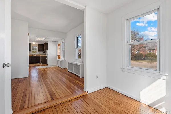 a view of a room with wooden floor and a window