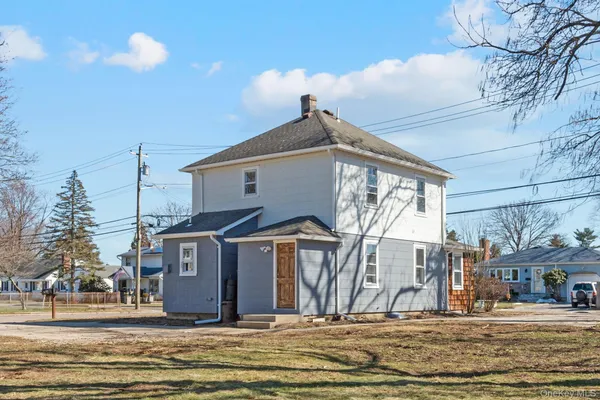 a view of a house next to a yard