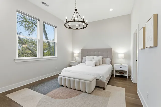 a bedroom with a large bed and a window