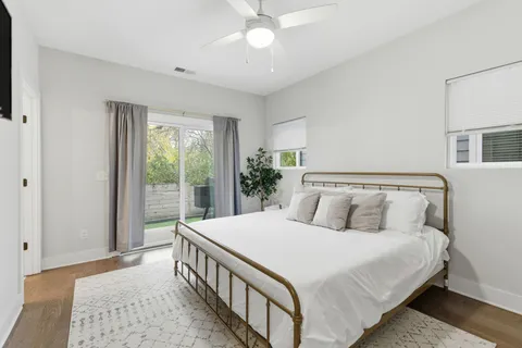 a bedroom with a bed and a large window