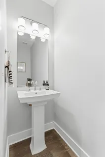a bathroom with a sink a mirror and vanity