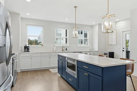a kitchen with a sink stove and refrigerator