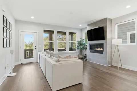 a living room with furniture a flat screen tv and a fireplace