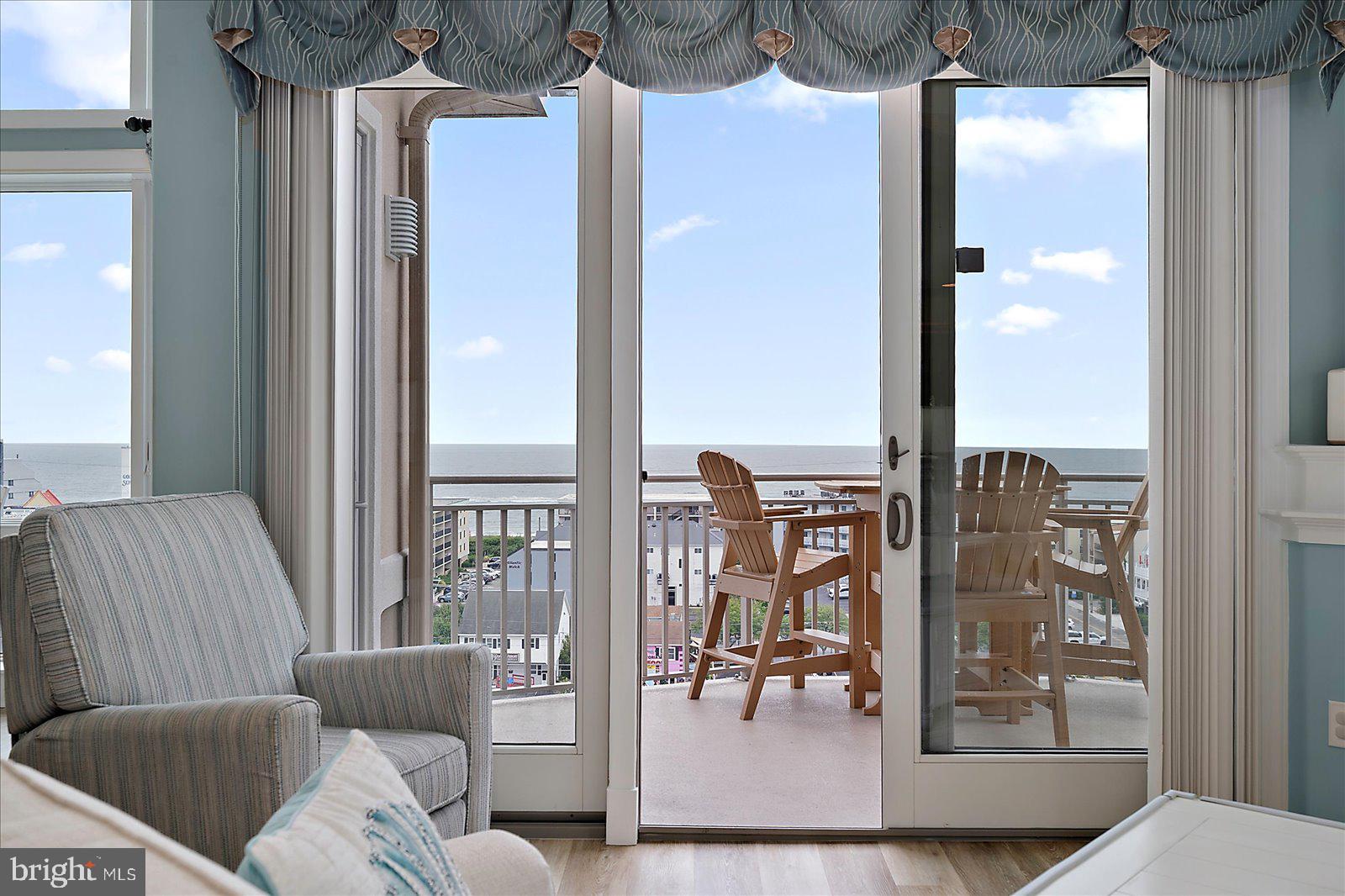 121 81st Street, Unit 907 Ocean City, MD 21842 - Photo 11 of 73 a living room with furniture and a floor to ceiling window