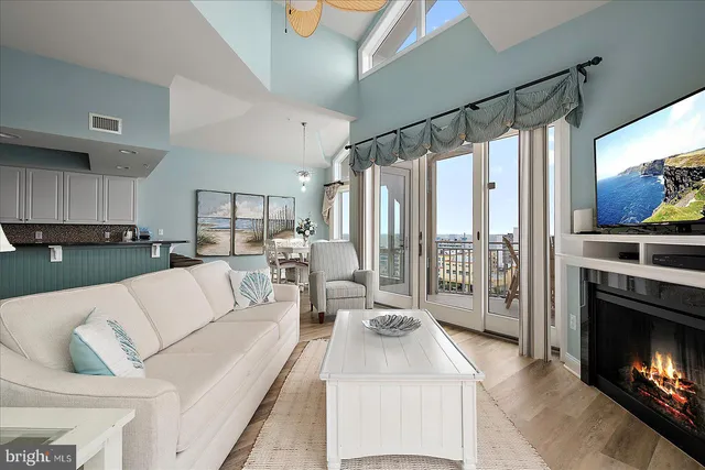a kitchen with stainless steel appliances granite countertop a white cabinets and a wooden floor