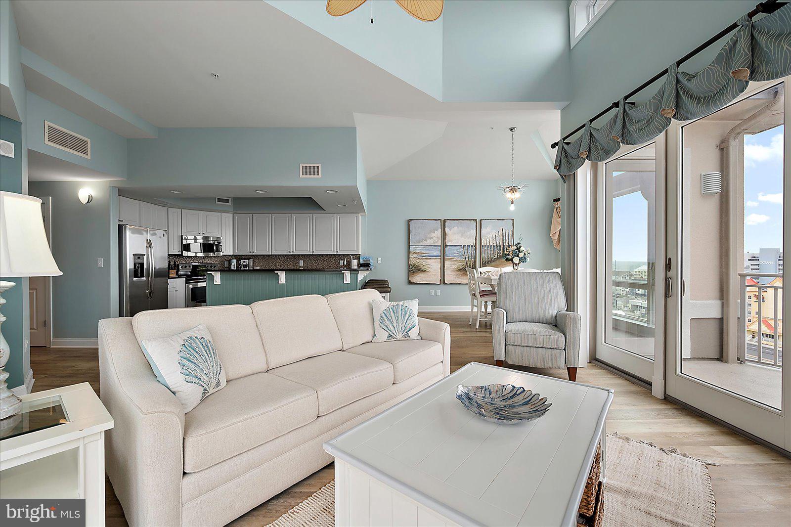 121 81st Street, Unit 907 Ocean City, MD 21842 - Photo 13 of 73 a living room with furniture and a table