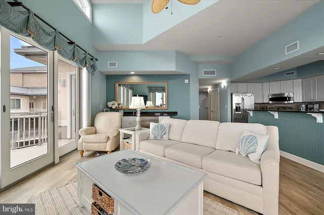 a kitchen with stainless steel appliances granite countertop a refrigerator a stove a sink and a microwave