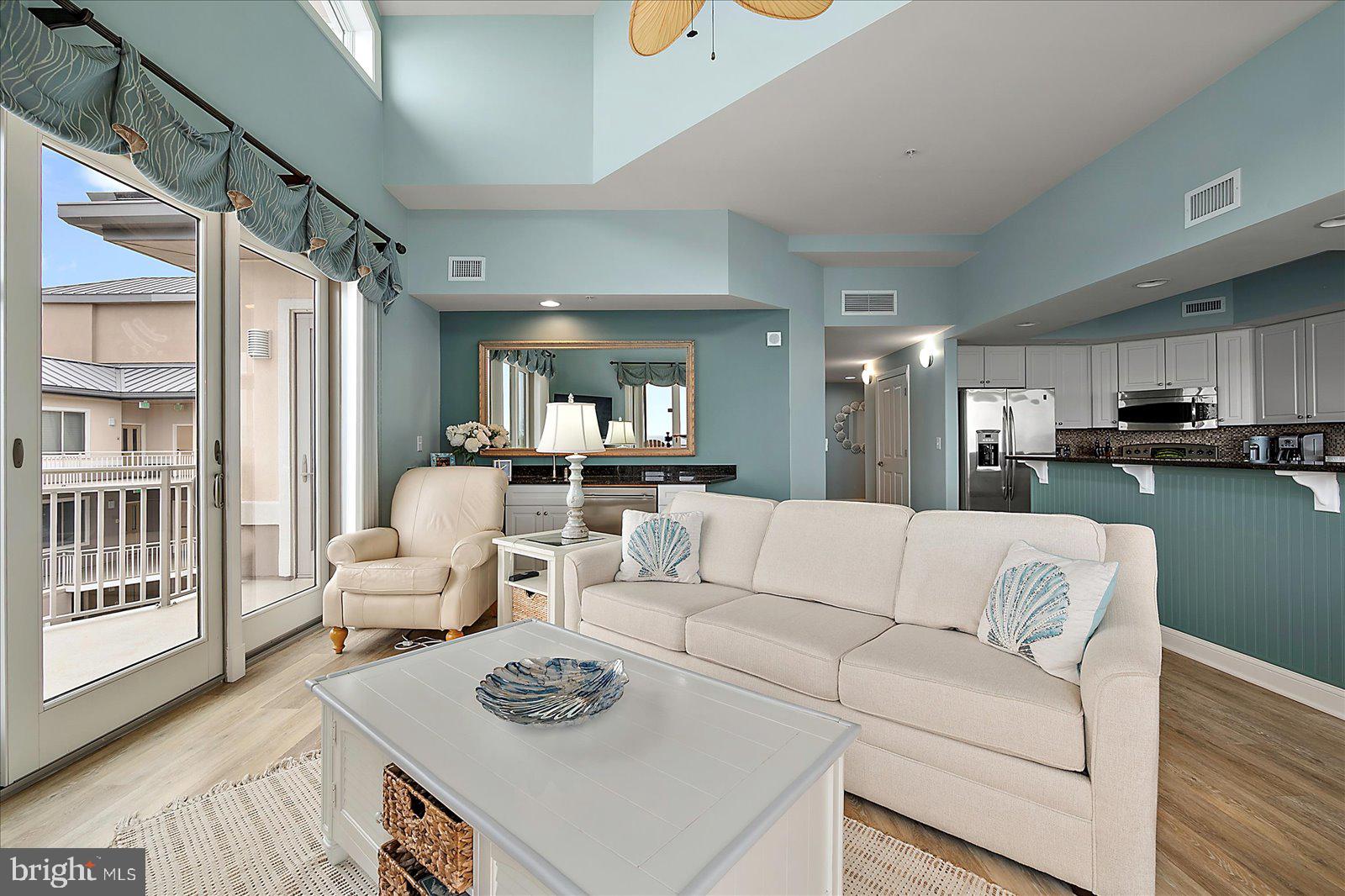 121 81st Street, Unit 907 Ocean City, MD 21842 - Photo 14 of 73 a living room with furniture and a table