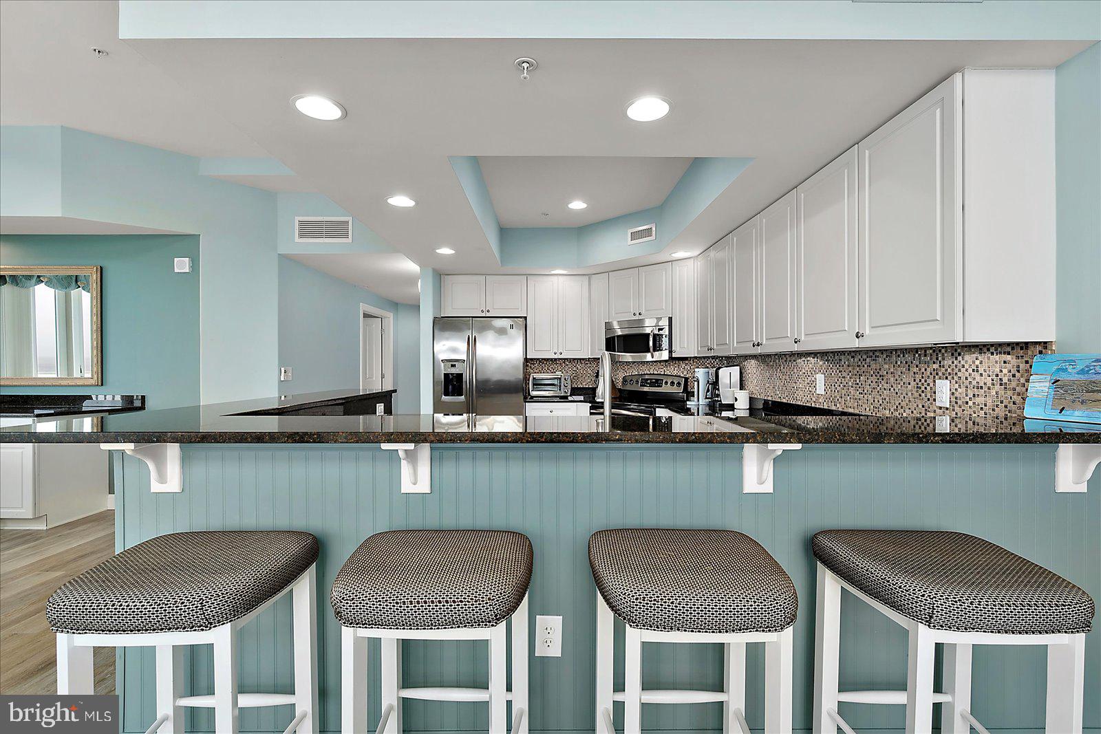 121 81st Street, Unit 907 Ocean City, MD 21842 - Photo 18 of 73 a kitchen with cabinets and chairs