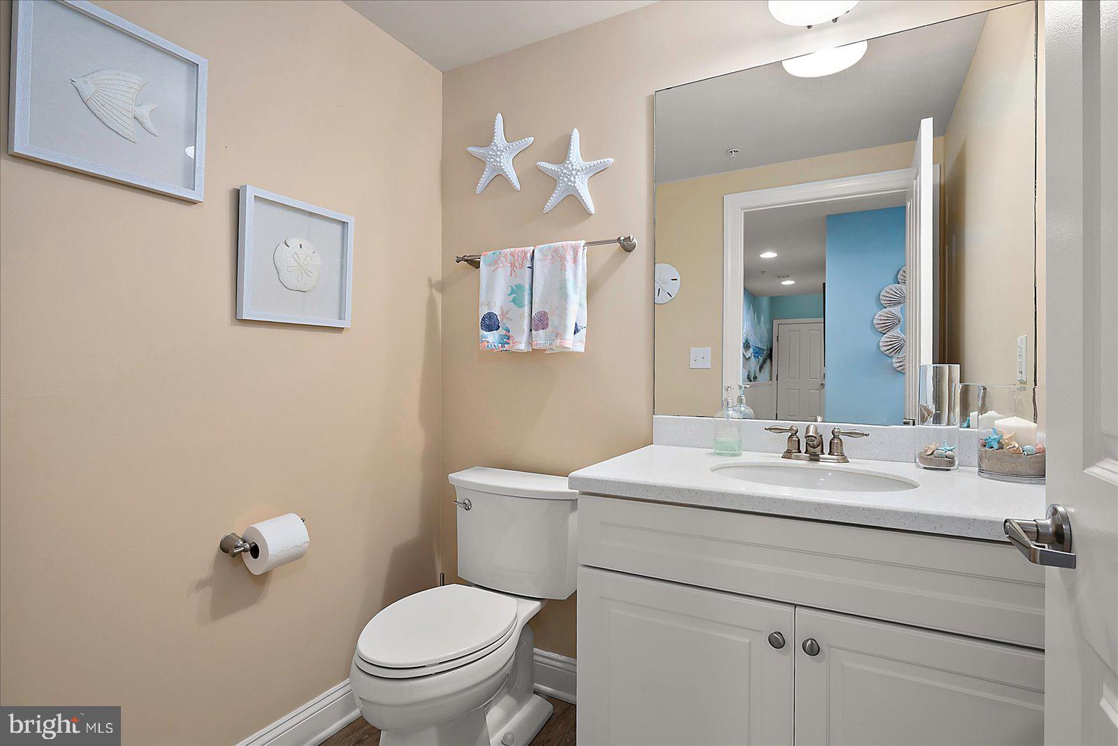 121 81st Street, Unit 907 Ocean City, MD 21842 - Photo 27 of 73 a bathroom with a toilet sink and mirror
