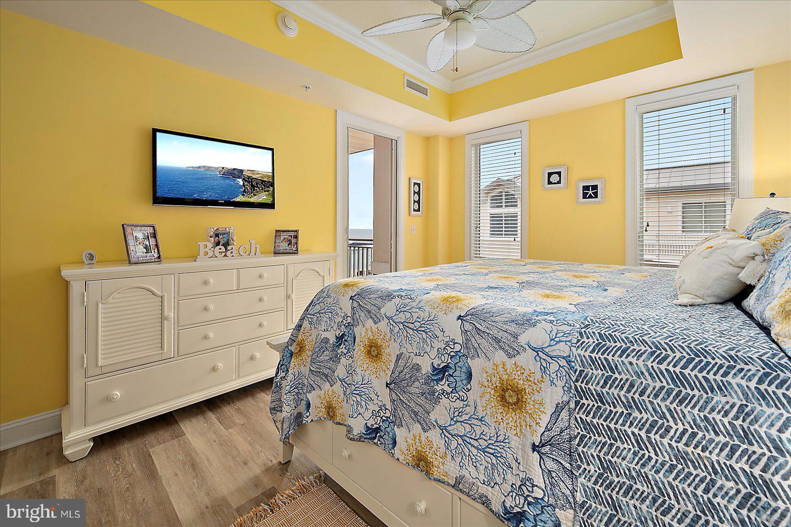 121 81st Street, Unit 907 Ocean City, MD 21842 - Photo 39 of 73 a bedroom with a bed and a flat tv screen on dresser