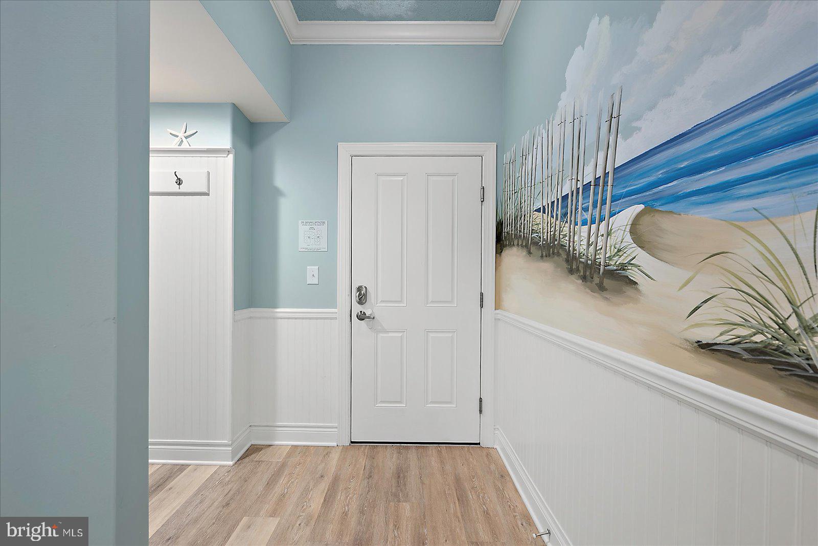 121 81st Street, Unit 907 Ocean City, MD 21842 - Photo 4 of 73 a view of a hallway with wooden floor and closet